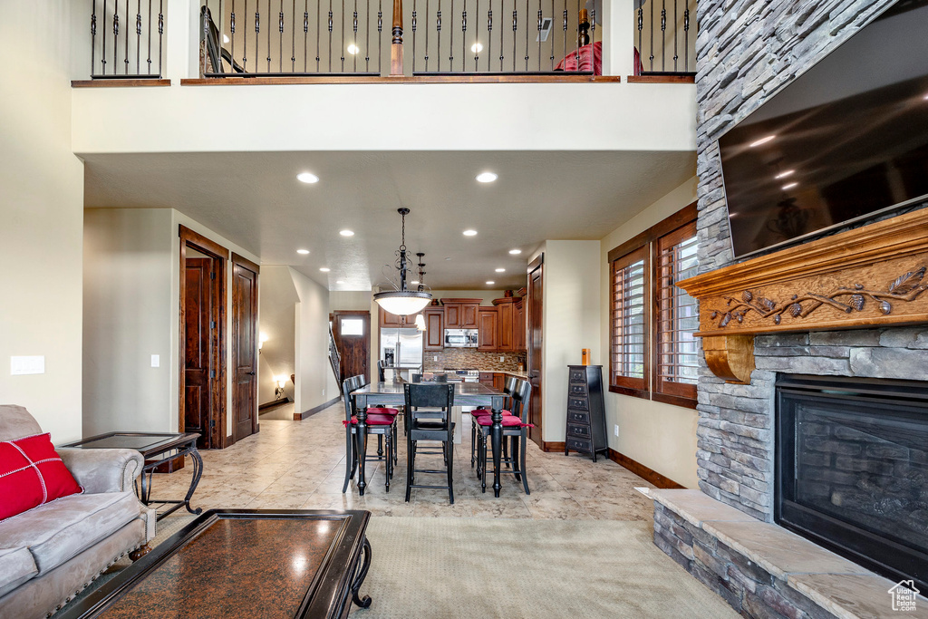 Living room featuring a stone fireplace and light carpet