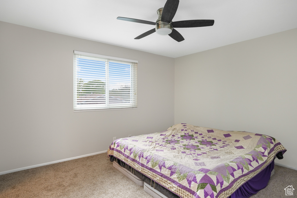 Carpeted bedroom with ceiling fan