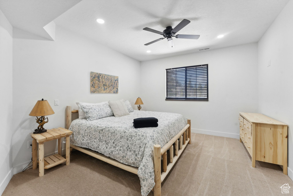 Carpeted bedroom with ceiling fan