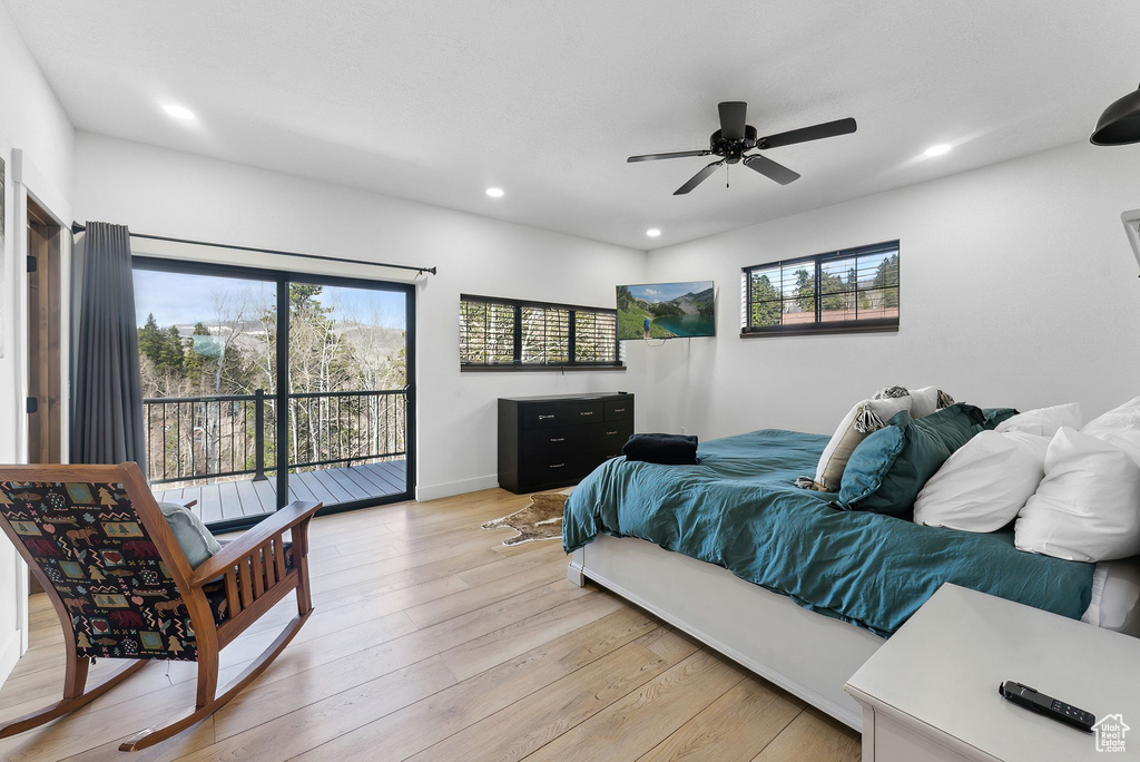 Bedroom with ceiling fan, light wood-type flooring, and access to exterior