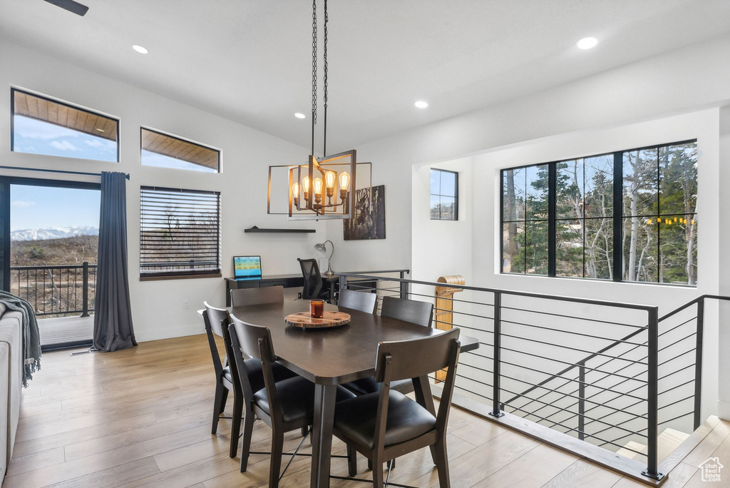 Dining area featuring a notable chandelier and light hardwood / wood-style flooring
