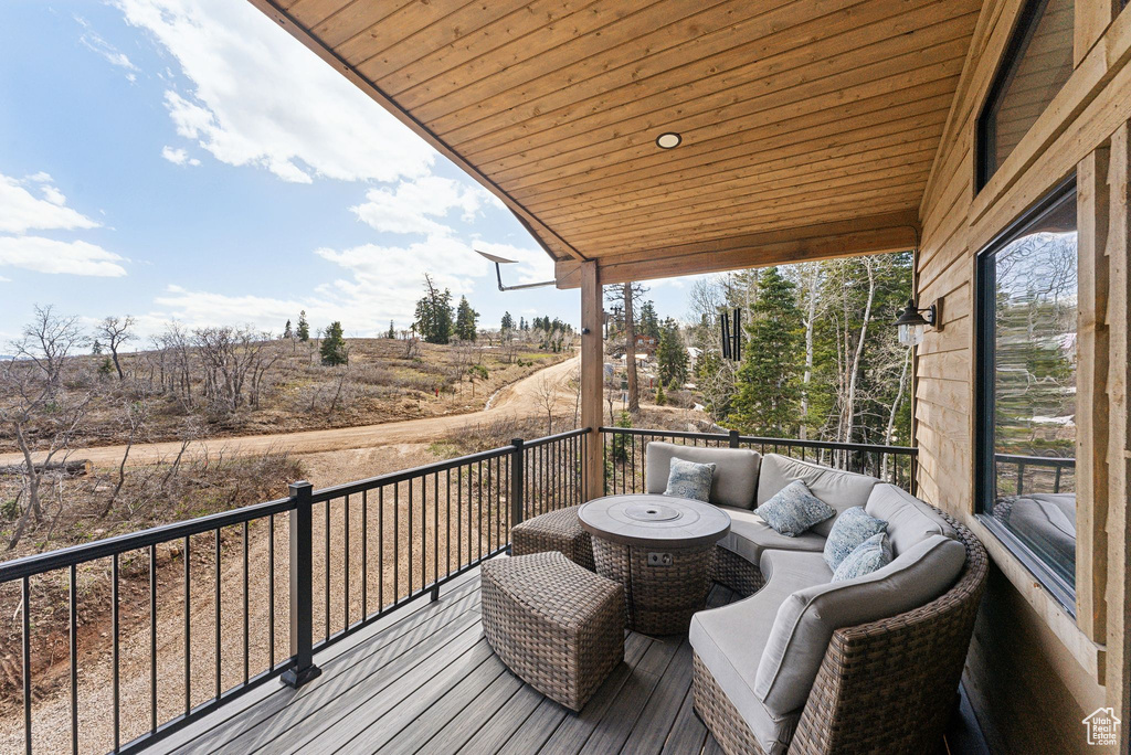 Wooden terrace with outdoor lounge area and a rural view