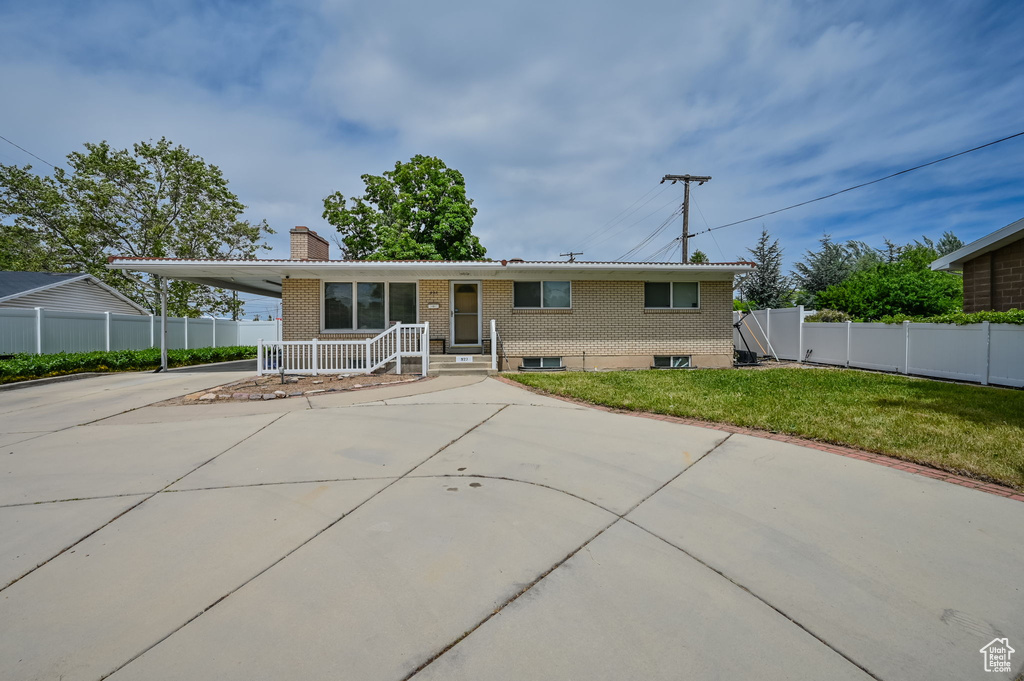 Rear view of house featuring a yard