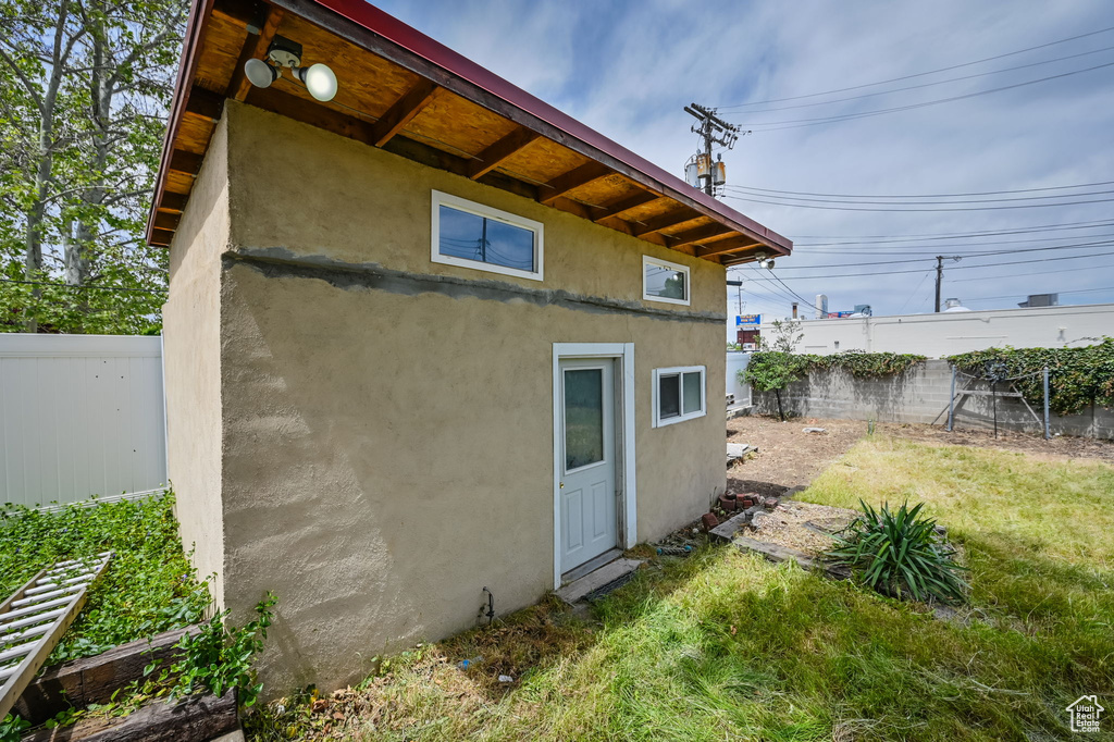 Back of house with a lawn