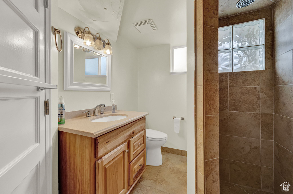 Bathroom with tile floors, toilet, and large vanity