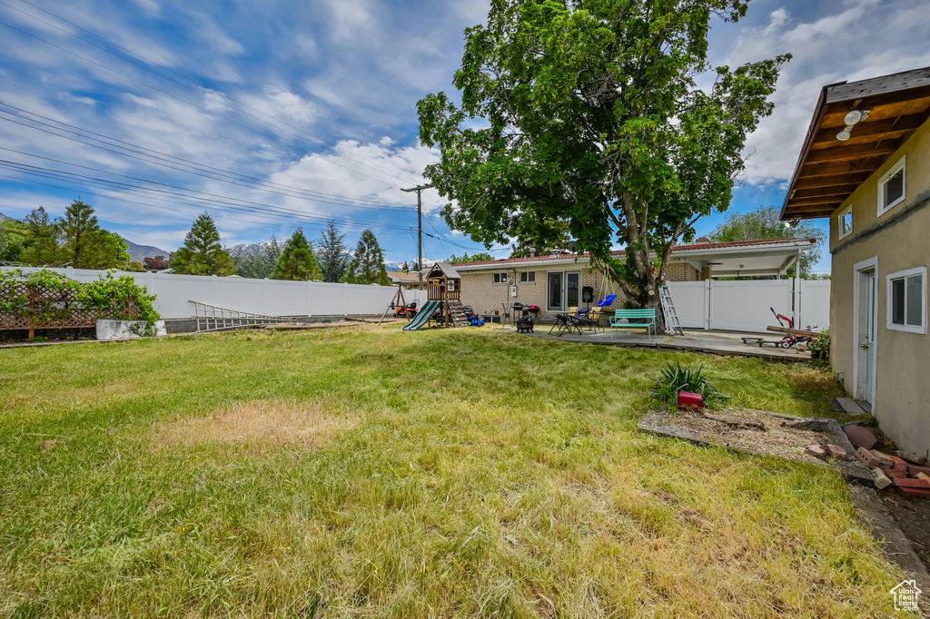 View of yard featuring a patio and a playground