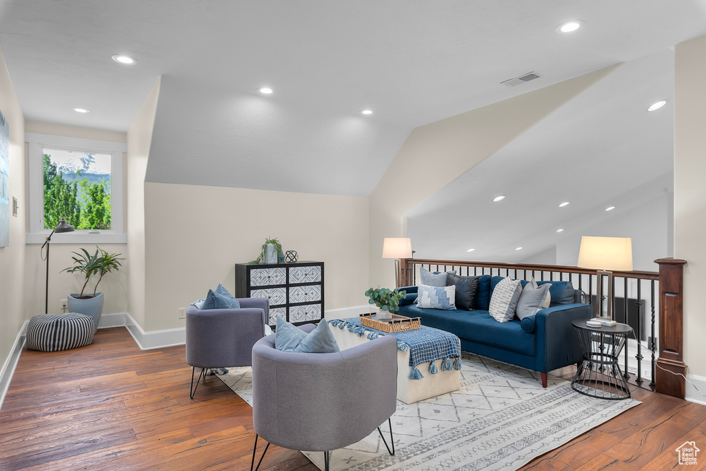 Living room featuring lofted ceiling and wood-type flooring