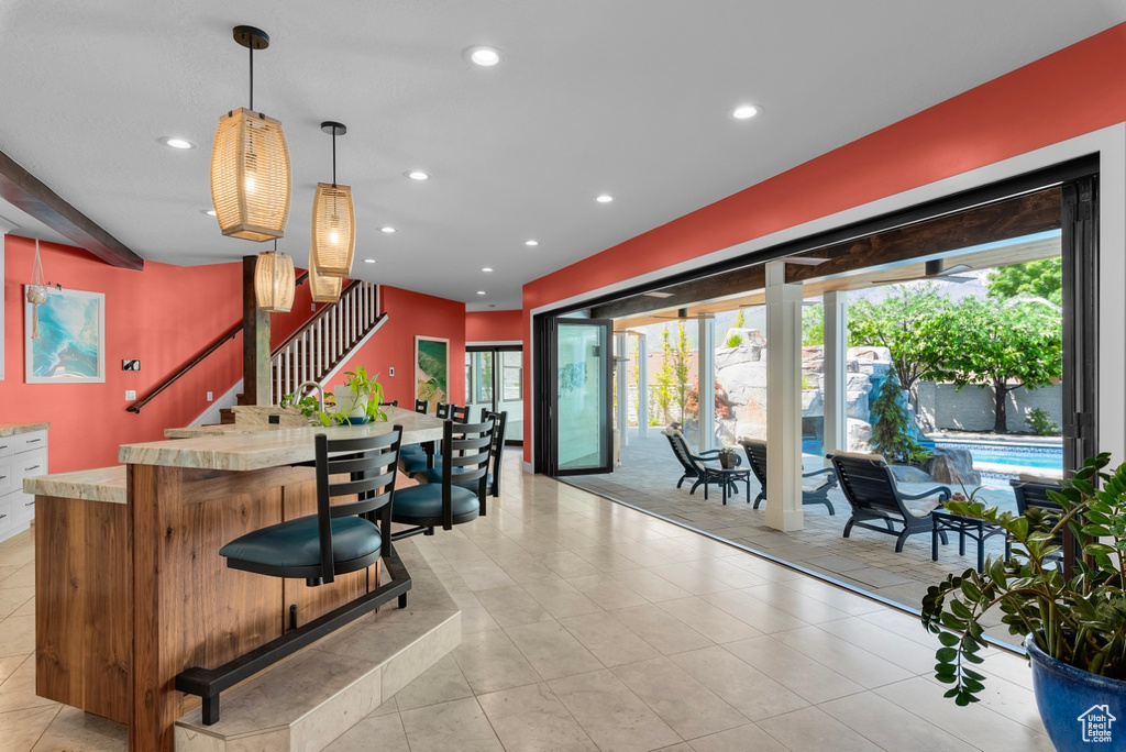 Kitchen featuring hanging light fixtures and light tile floors