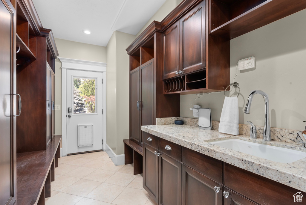 Laundry area with sink and light tile floors