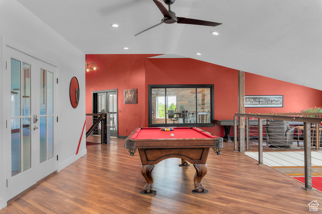 Rec room featuring billiards, french doors, hardwood / wood-style flooring, and lofted ceiling