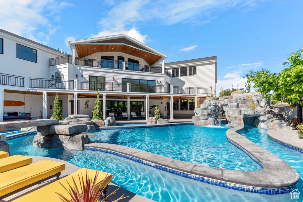 View of swimming pool featuring a patio area and pool water feature