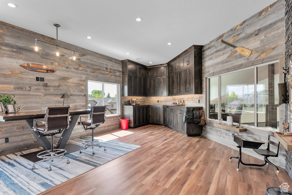 Office with wooden walls and wood-type flooring