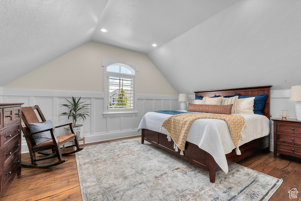 Bedroom featuring dark hardwood / wood-style floors and vaulted ceiling