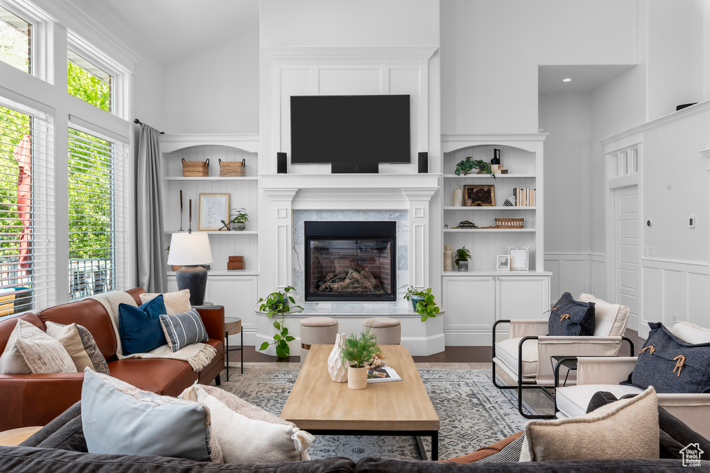 Living room featuring high vaulted ceiling and hardwood / wood-style flooring