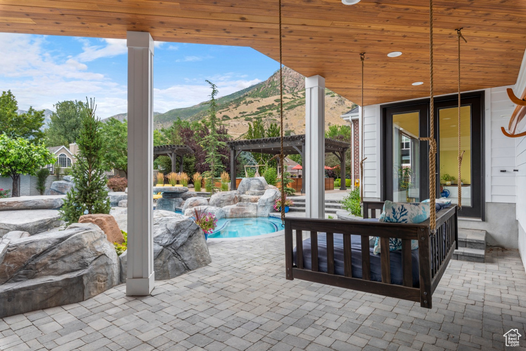 View of patio with a mountain view and an outdoor hangout area