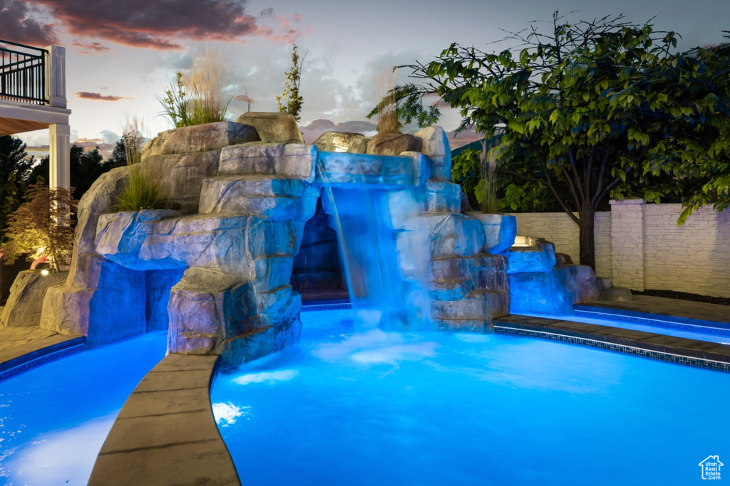 Pool at dusk with pool water feature