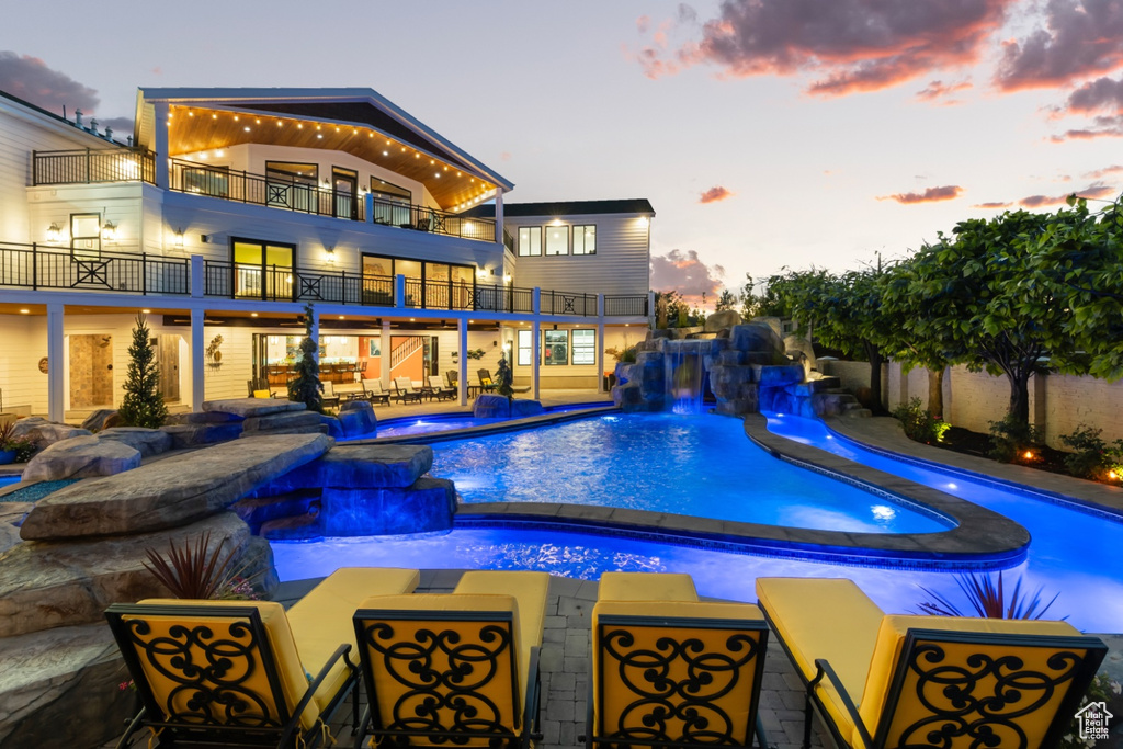 Pool at dusk with pool water feature