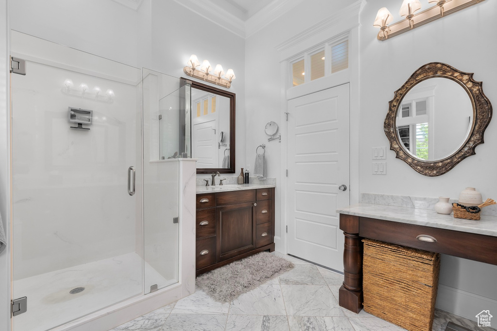 Bathroom with tile flooring, walk in shower, vanity, and ornamental molding