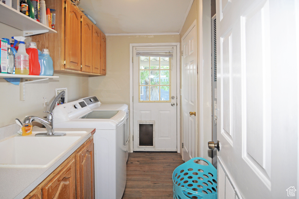 Washroom with cabinets, washer and clothes dryer, washer hookup, dark hardwood / wood-style floors, and sink