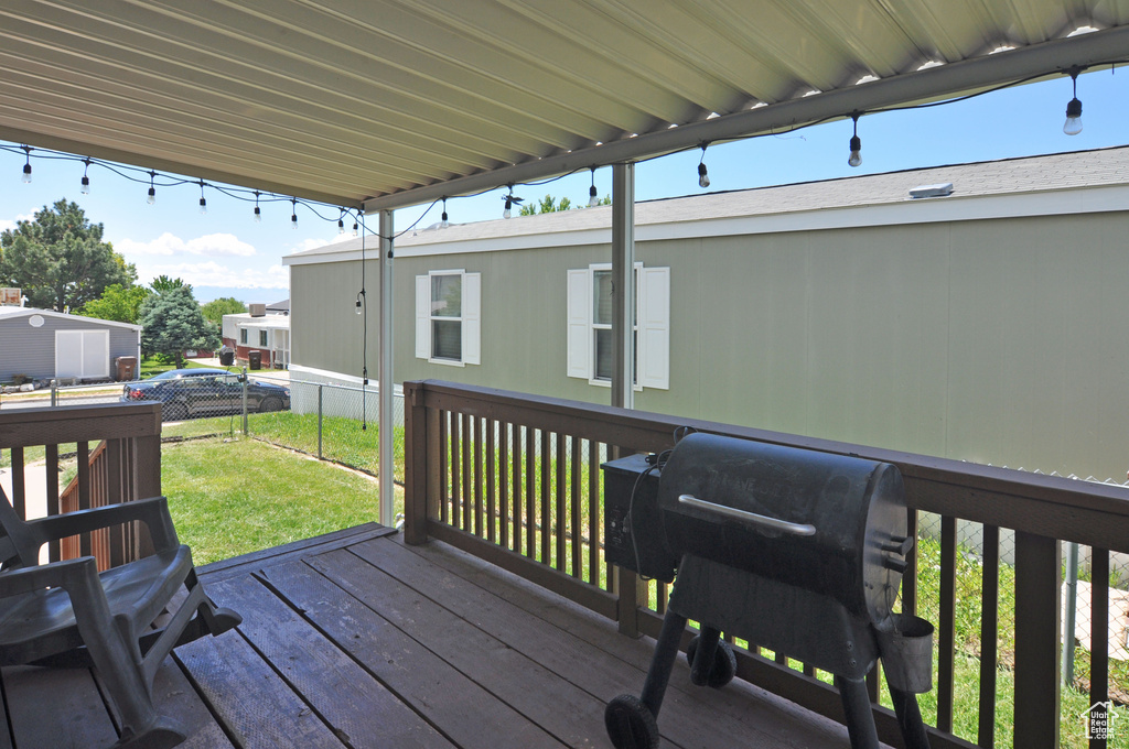 Wooden terrace featuring a yard