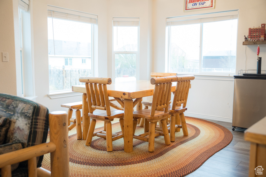 Dining space featuring a wealth of natural light and hardwood / wood-style floors