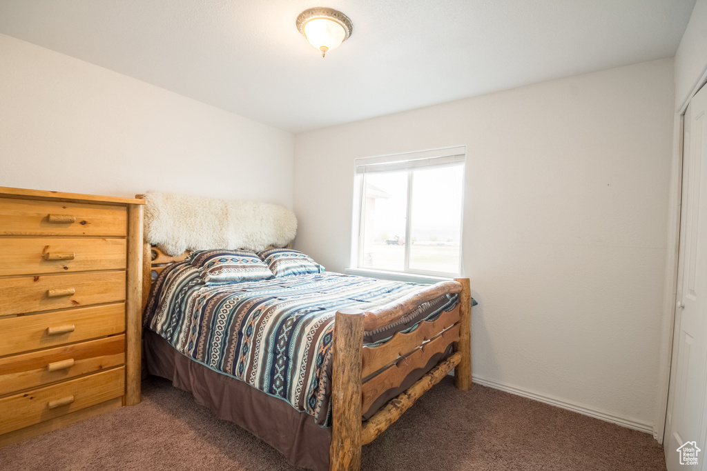 Bedroom with dark colored carpet