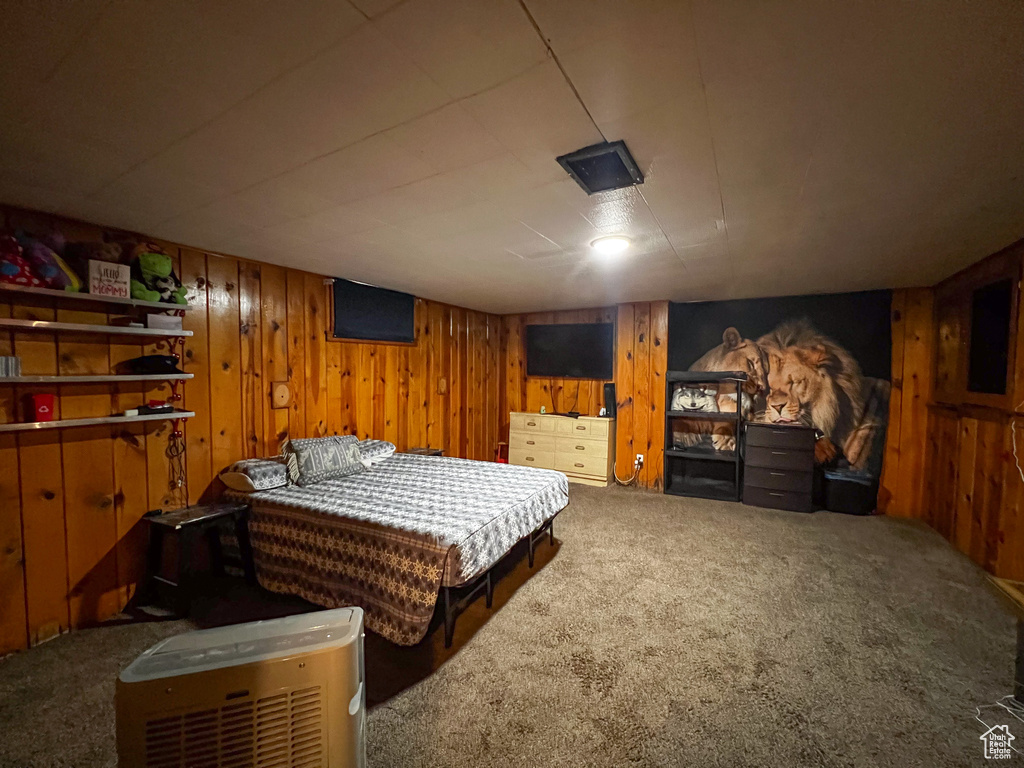 Carpeted bedroom with wooden walls