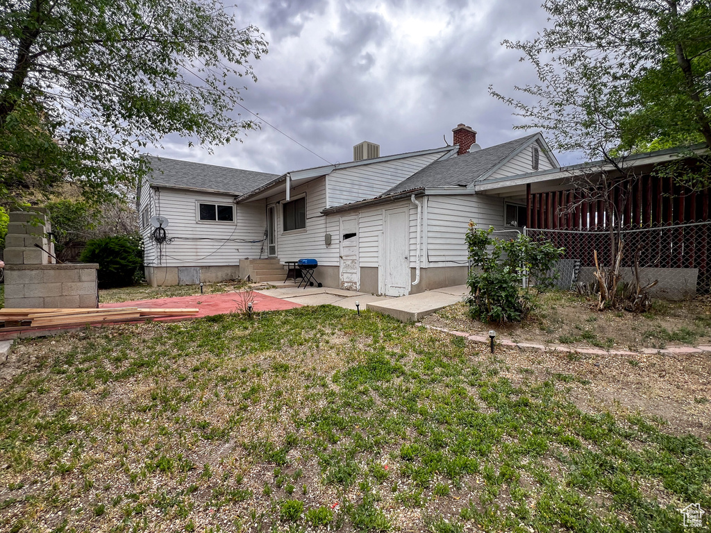 Rear view of house featuring a yard and a patio