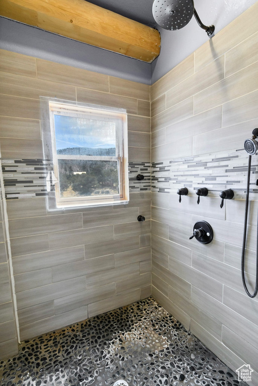 Full bath with a tile shower