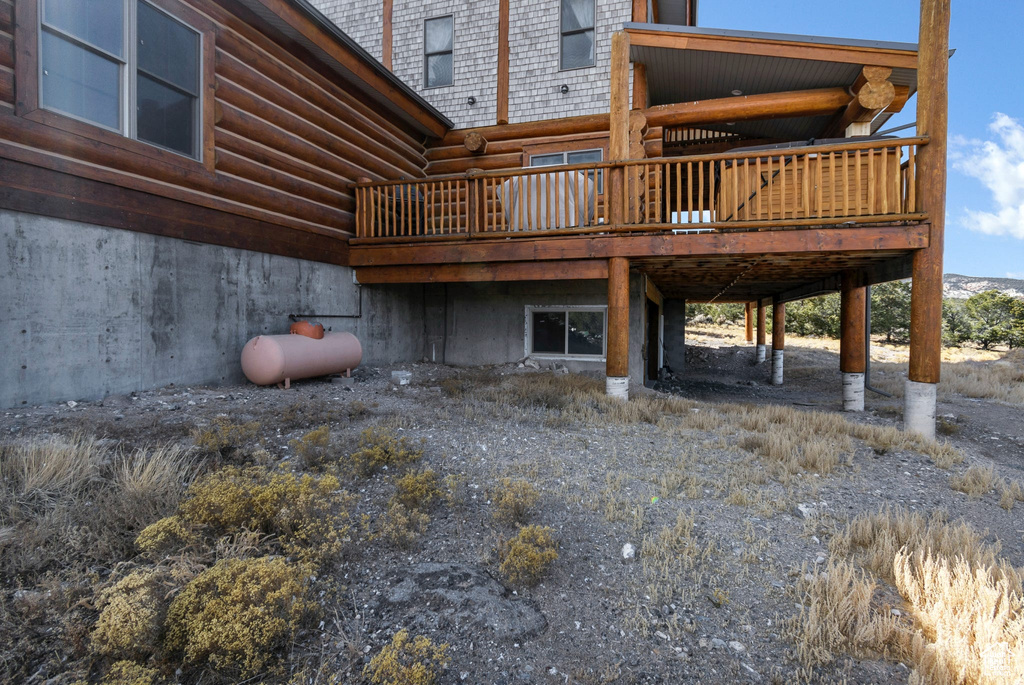 Exterior space with log exterior and a deck