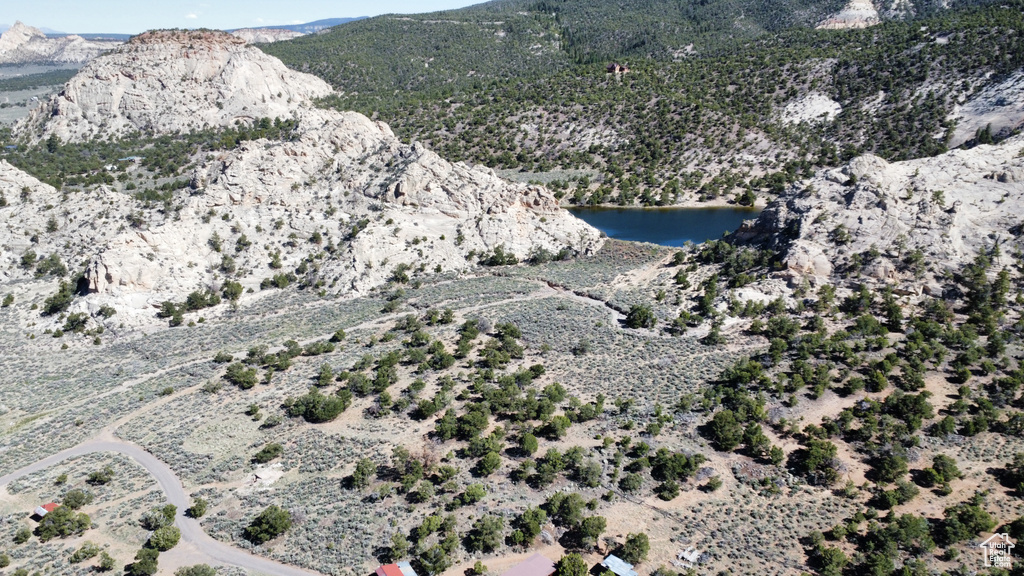 Drone / aerial view with a water and mountain view