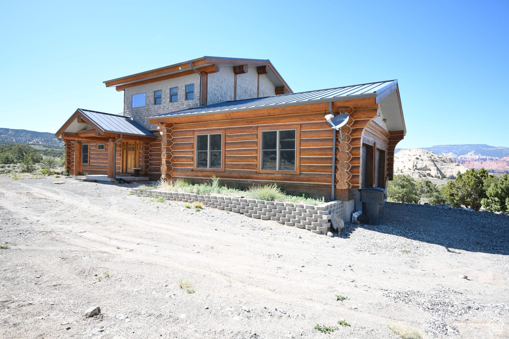 Log-style house featuring a garage and a mountain view