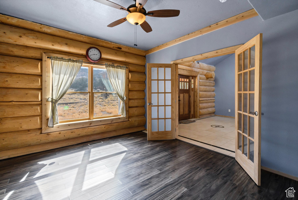 Unfurnished room with ceiling fan, visible vents, baseboards, french doors, and dark wood-style floors