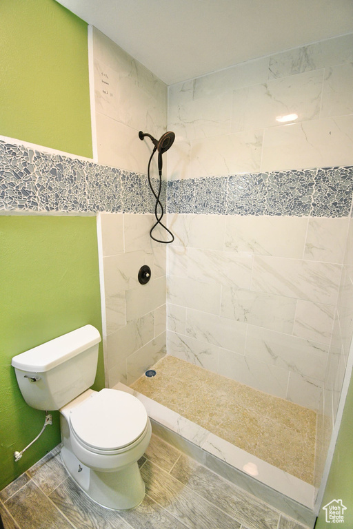 Full bathroom with a stall shower and toilet