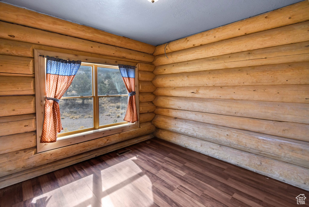 Spare room with visible vents and wood finished floors