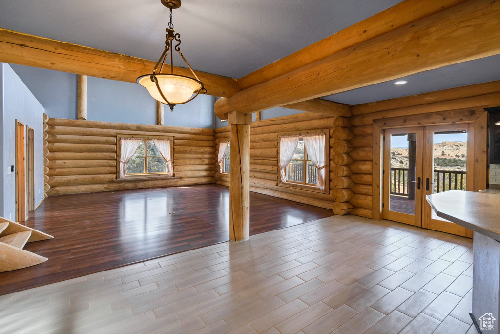 Interior space featuring wood finished floors, beamed ceiling, and french doors