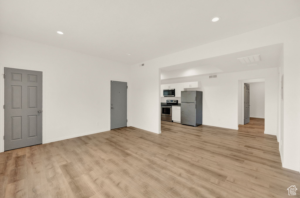 Unfurnished living room with light hardwood / wood-style floors
