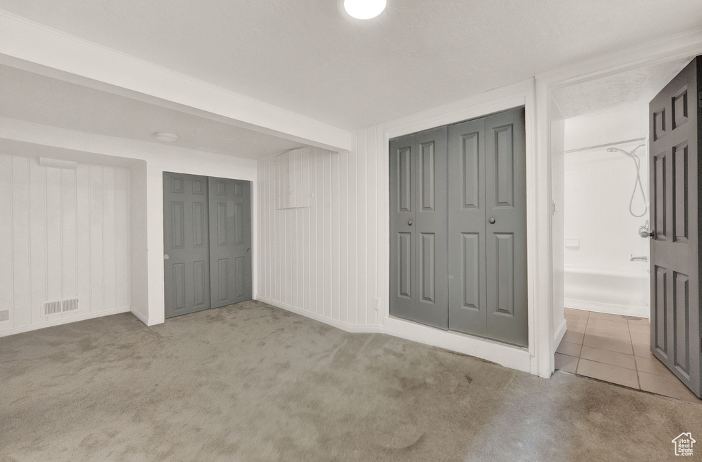 Unfurnished bedroom featuring beam ceiling and carpet floors