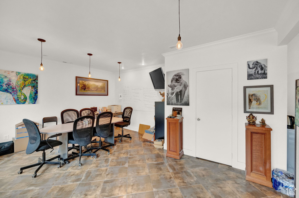 Dining room featuring tile floors and ornamental molding