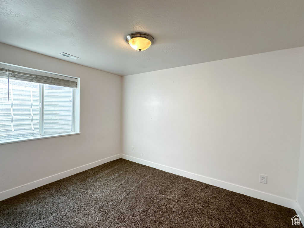 Empty room featuring carpet flooring