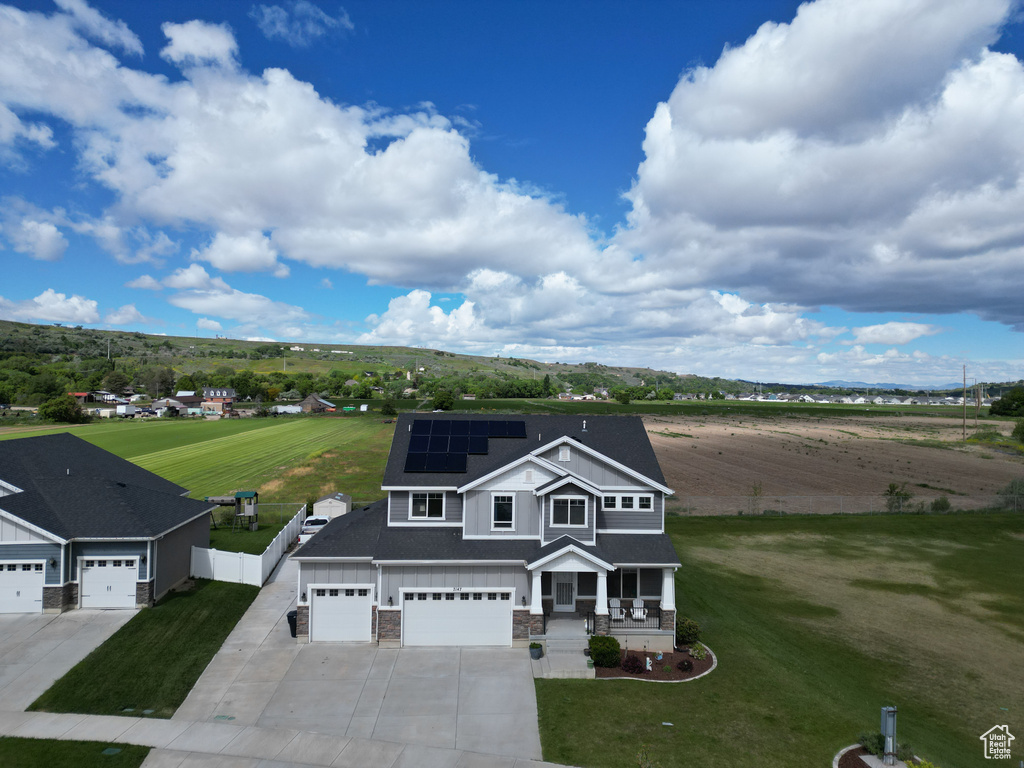 View of front of property featuring a front lawn and a garage