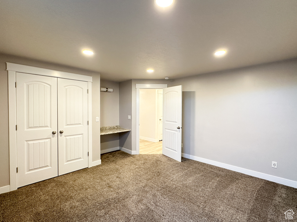 Unfurnished bedroom with carpet and a closet