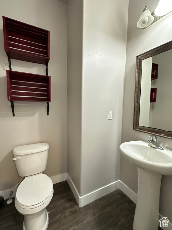 Bathroom featuring sink, hardwood / wood-style floors, and toilet