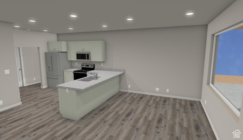 Kitchen featuring kitchen peninsula, light wood-type flooring, white cabinetry, and appliances with stainless steel finishes