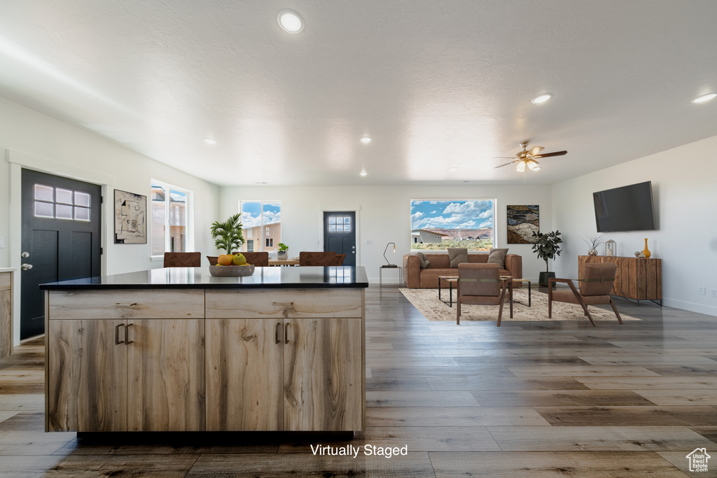 Kitchen featuring dark wood-type flooring, ceiling fan, and light brown cabinets