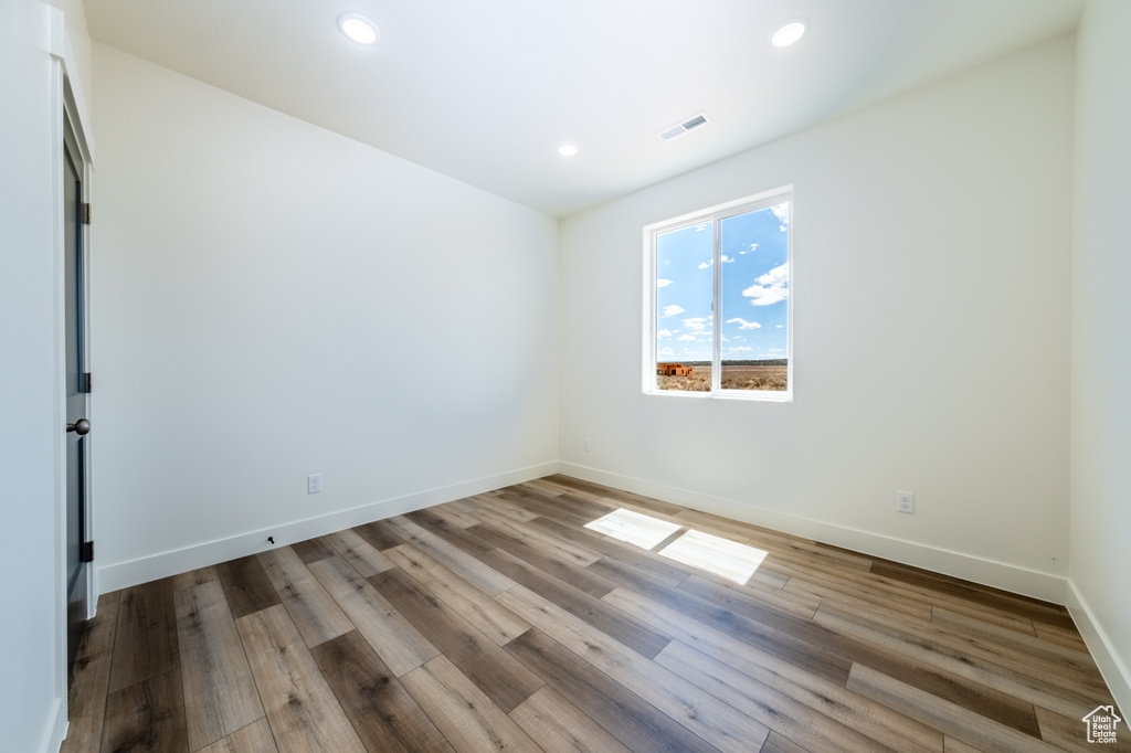 Empty room featuring wood-type flooring