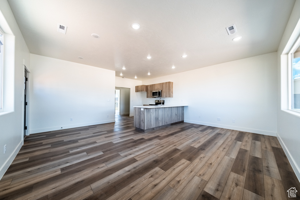 Unfurnished living room with dark hardwood / wood-style floors