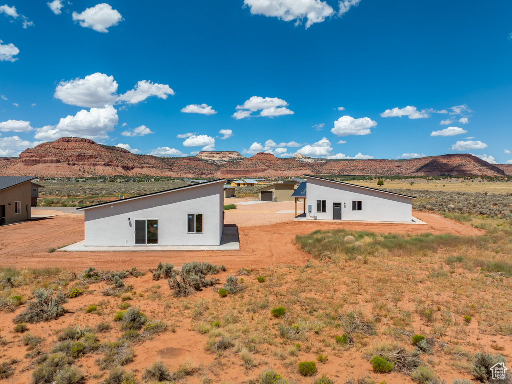 Back of property with a mountain view