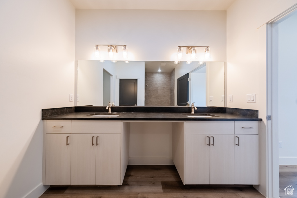 Bathroom featuring vanity and wood-type flooring