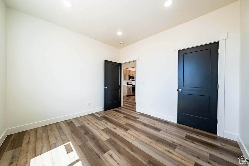 Unfurnished bedroom featuring hardwood / wood-style flooring